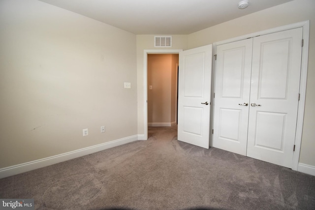 unfurnished bedroom featuring a closet and carpet