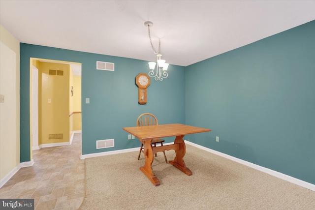 dining area featuring an inviting chandelier