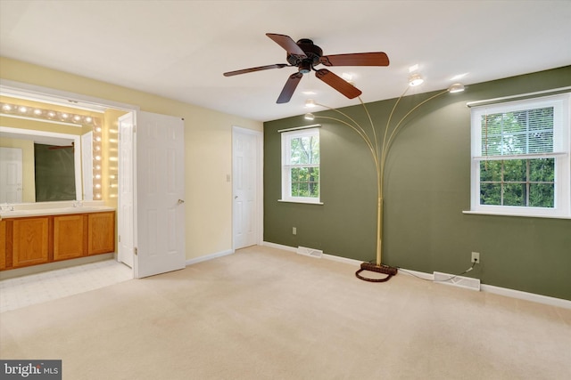 unfurnished bedroom with ceiling fan and light carpet