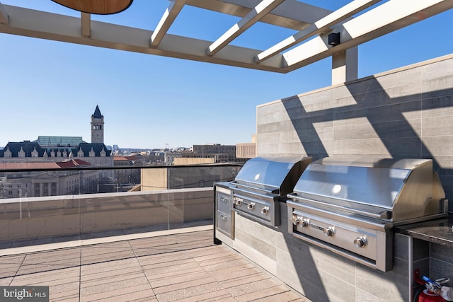 view of patio / terrace featuring a view of city, area for grilling, and a pergola