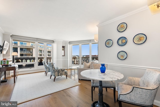 sitting room featuring crown molding and wood finished floors