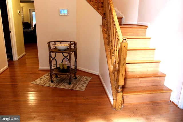 stairs featuring hardwood / wood-style flooring