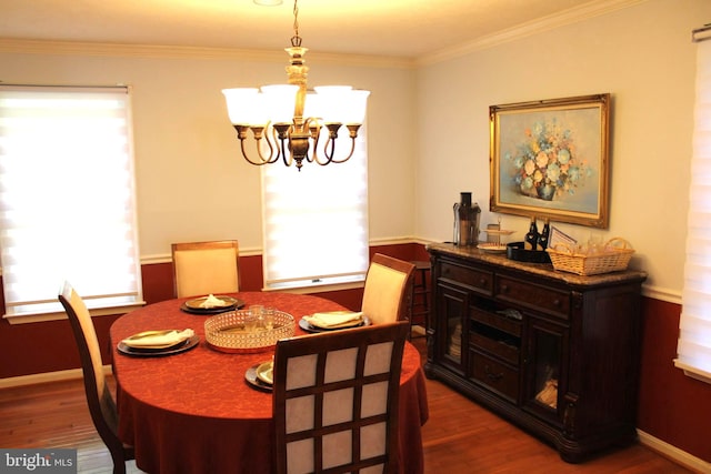 dining room featuring ornamental molding, dark hardwood / wood-style flooring, and a chandelier