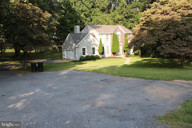 view of front facade featuring a garage and a front lawn