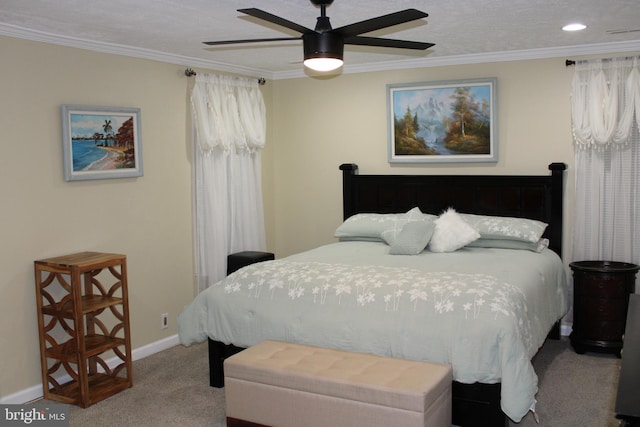 carpeted bedroom with a textured ceiling, ceiling fan, and ornamental molding