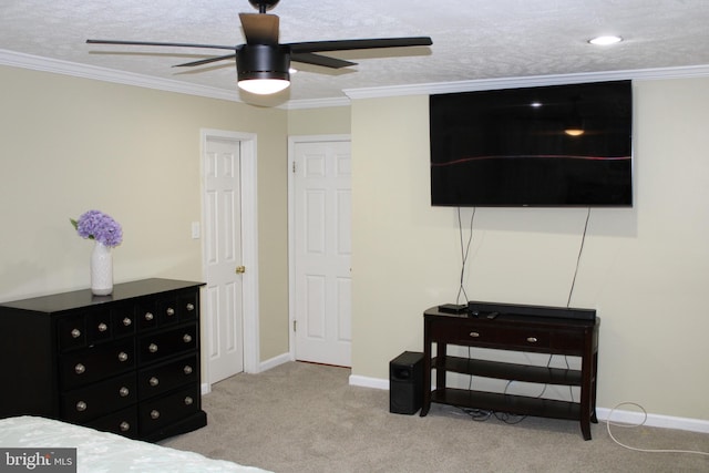 bedroom with a textured ceiling, ceiling fan, ornamental molding, and light carpet