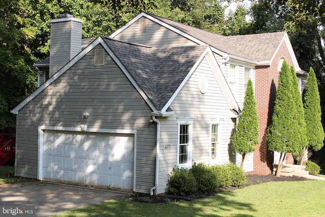 view of home's exterior with a lawn and a garage