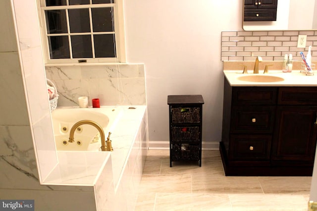 bathroom with a tub, vanity, and backsplash