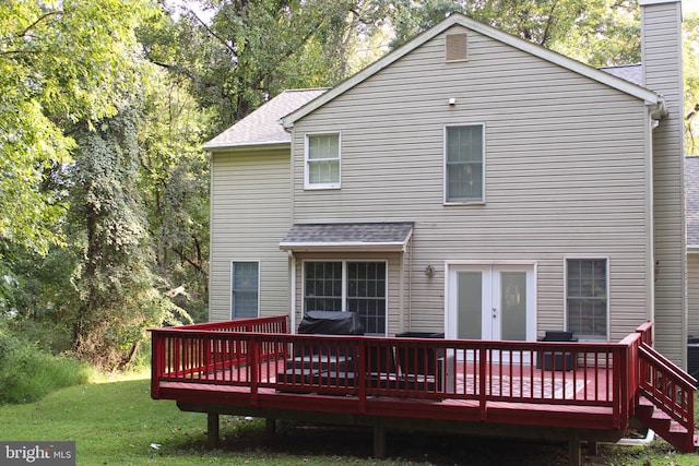 back of house featuring a yard and a wooden deck