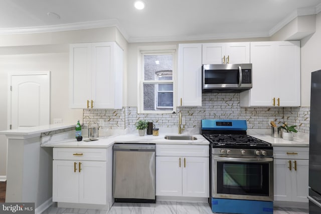 kitchen featuring appliances with stainless steel finishes, white cabinetry, and sink