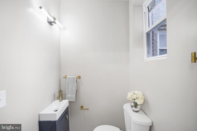 bathroom featuring sink, toilet, and a wealth of natural light