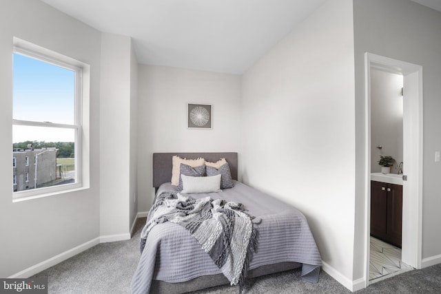 carpeted bedroom with connected bathroom