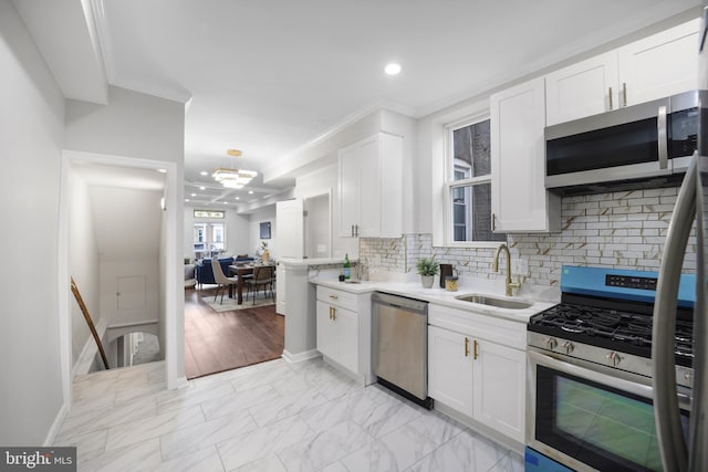 kitchen featuring stainless steel appliances, crown molding, sink, and white cabinetry