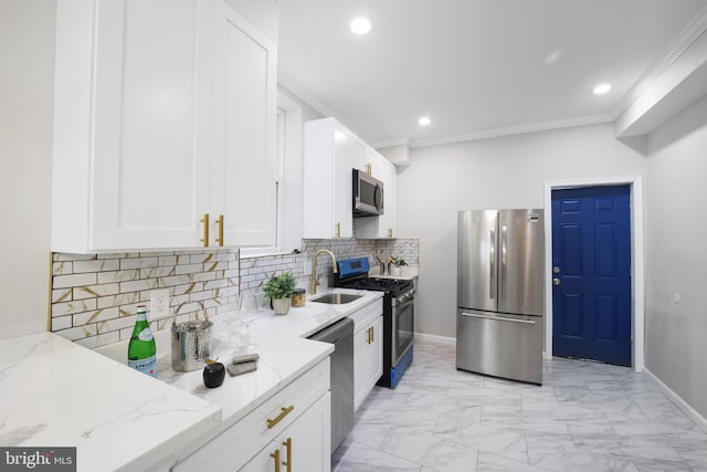 kitchen with light stone countertops, stainless steel appliances, white cabinetry, and crown molding