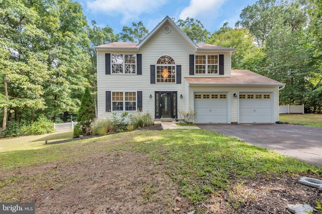 view of front of home featuring a garage and a front lawn