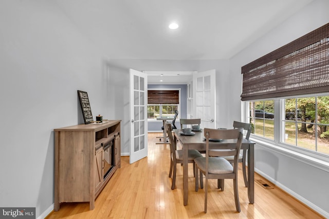 dining space featuring a wealth of natural light and light hardwood / wood-style flooring