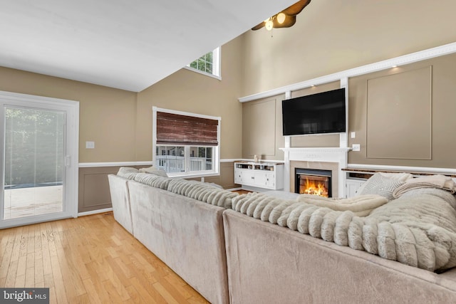 living room with light hardwood / wood-style flooring and ceiling fan