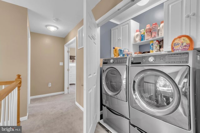 washroom featuring independent washer and dryer and light carpet