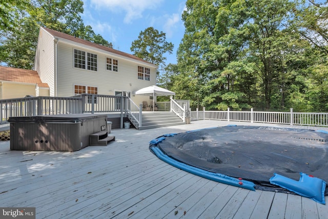 wooden terrace featuring a hot tub