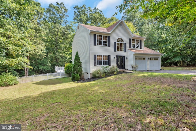 view of front of house with a garage and a front lawn