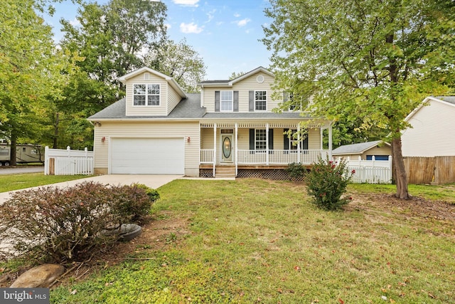 view of front of home featuring a front lawn, a porch, and a garage