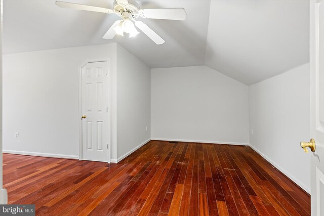 bonus room with vaulted ceiling, dark hardwood / wood-style floors, and ceiling fan