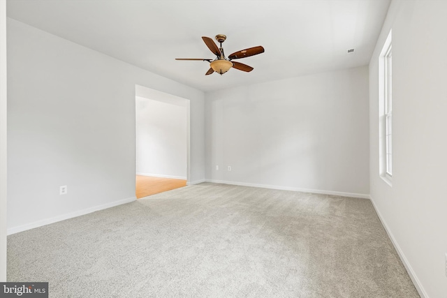 unfurnished room featuring light carpet and ceiling fan