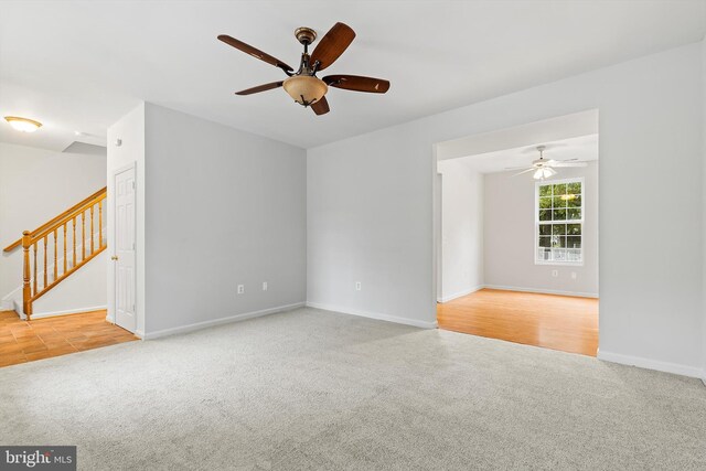 spare room featuring ceiling fan and light carpet