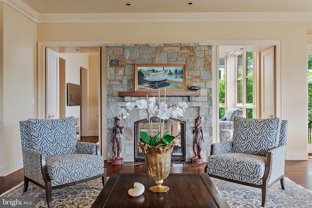 living room featuring crown molding, a fireplace, and dark hardwood / wood-style flooring