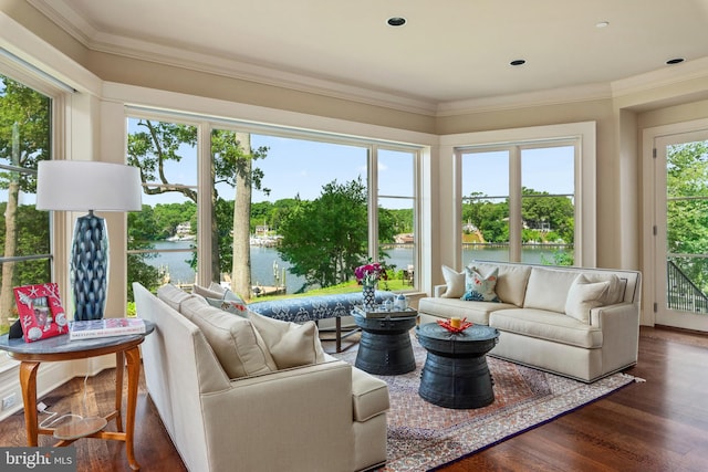 living room with a water view, crown molding, and dark hardwood / wood-style flooring