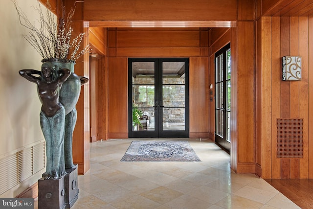 doorway featuring french doors and wood walls