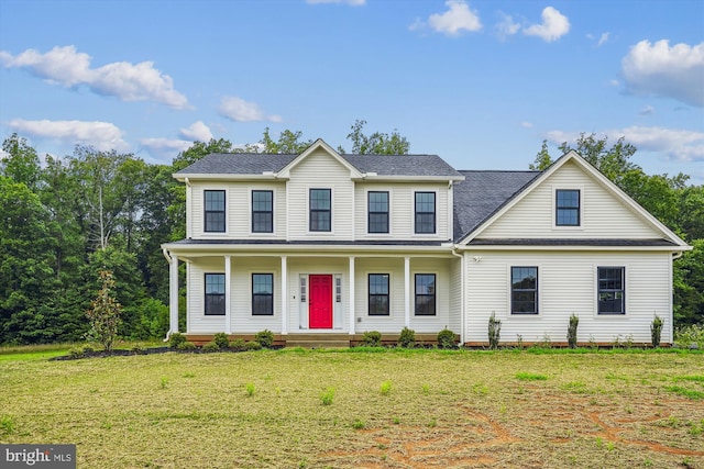 view of front facade featuring covered porch and a front yard