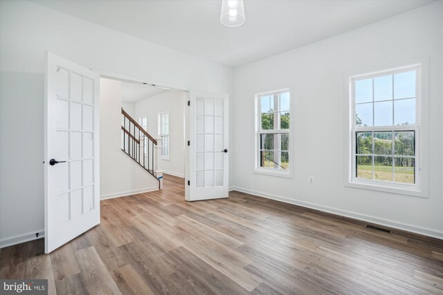 unfurnished room featuring light hardwood / wood-style flooring