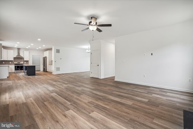 unfurnished living room featuring hardwood / wood-style floors and ceiling fan