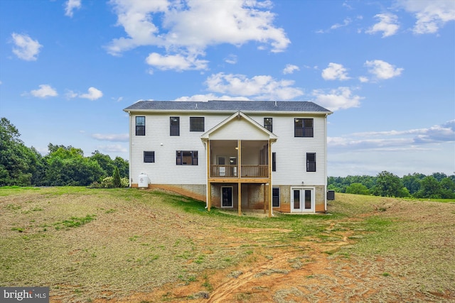 back of property featuring central AC unit and a yard