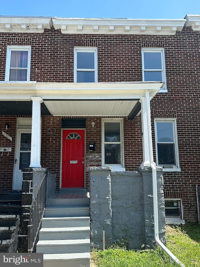 townhome / multi-family property featuring a porch