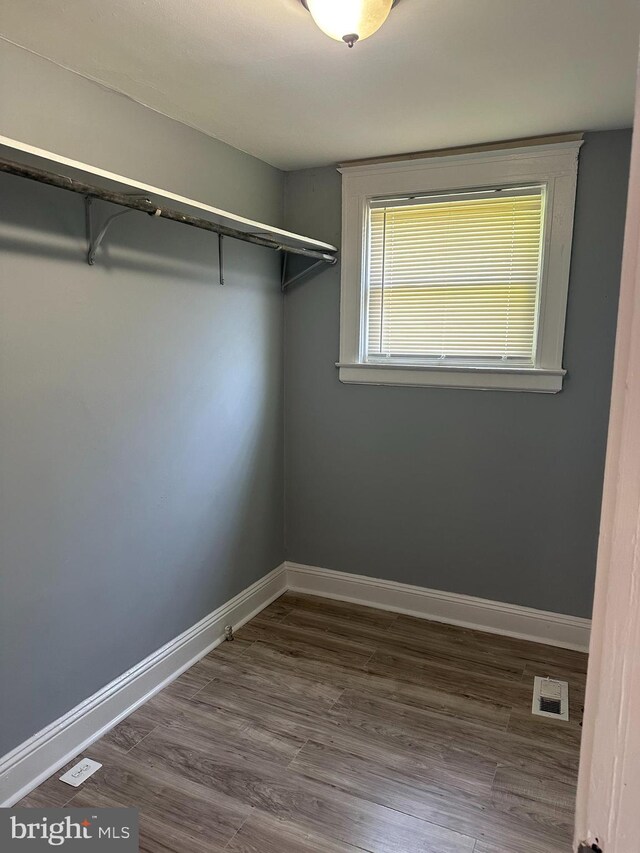 spacious closet featuring hardwood / wood-style floors