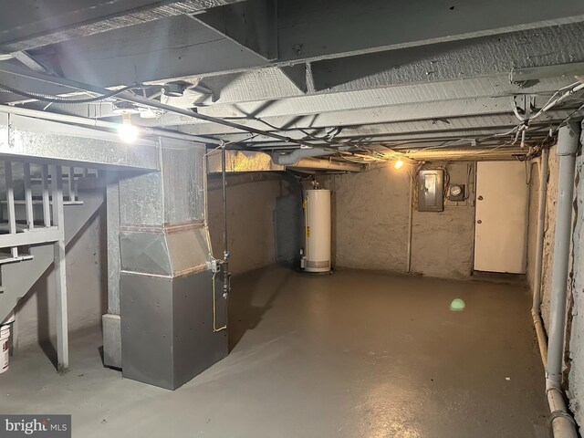 basement featuring electric panel, heating unit, and water heater