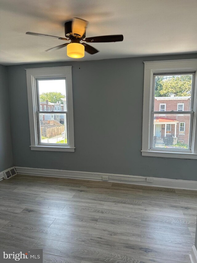 unfurnished room featuring light wood-type flooring and ceiling fan