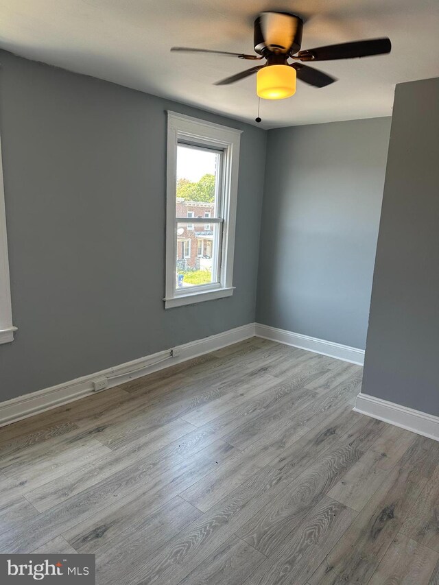 spare room with light hardwood / wood-style flooring and ceiling fan