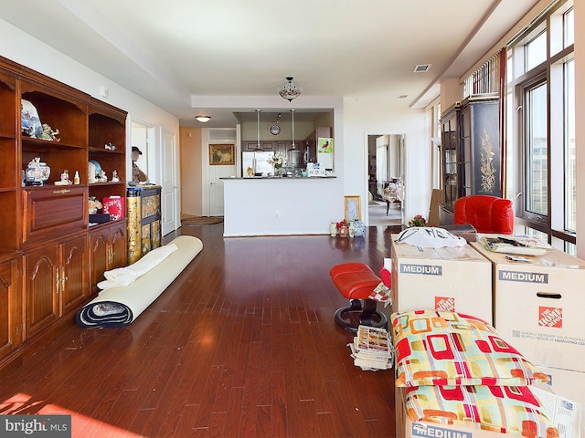 living room featuring plenty of natural light and dark wood-type flooring