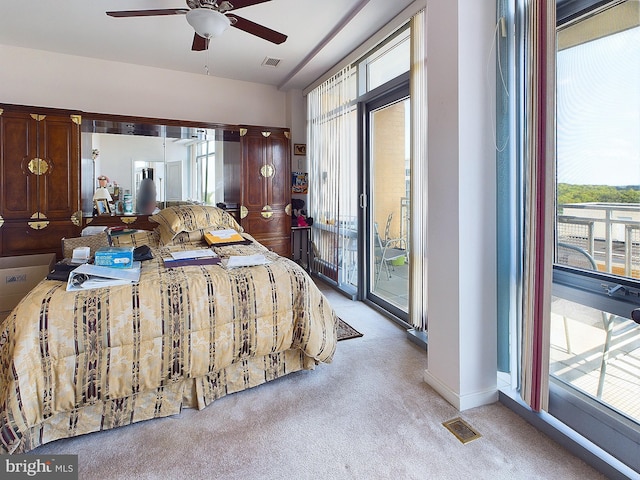 bedroom featuring light colored carpet, access to outside, and ceiling fan