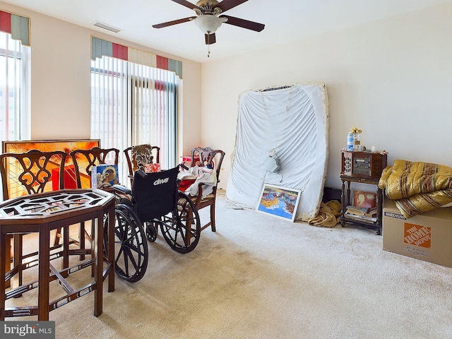 sitting room featuring ceiling fan and light colored carpet