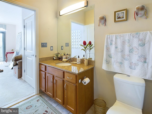 bathroom with vanity, toilet, and tile patterned flooring