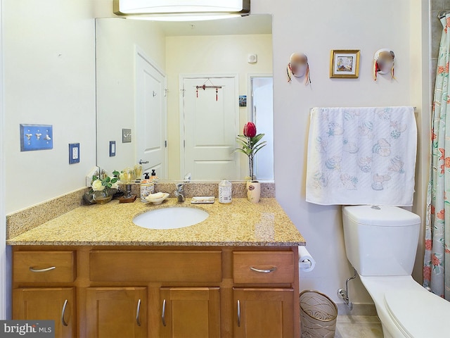 bathroom featuring toilet and vanity