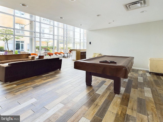 rec room with hardwood / wood-style flooring, expansive windows, and pool table