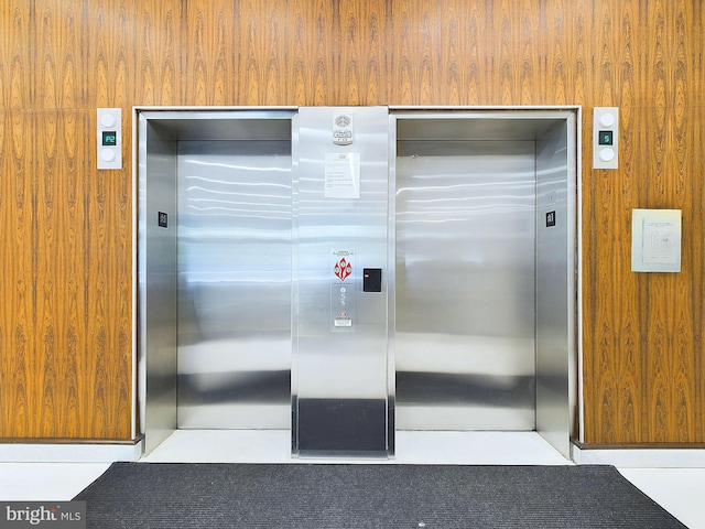 room details with elevator and wood walls