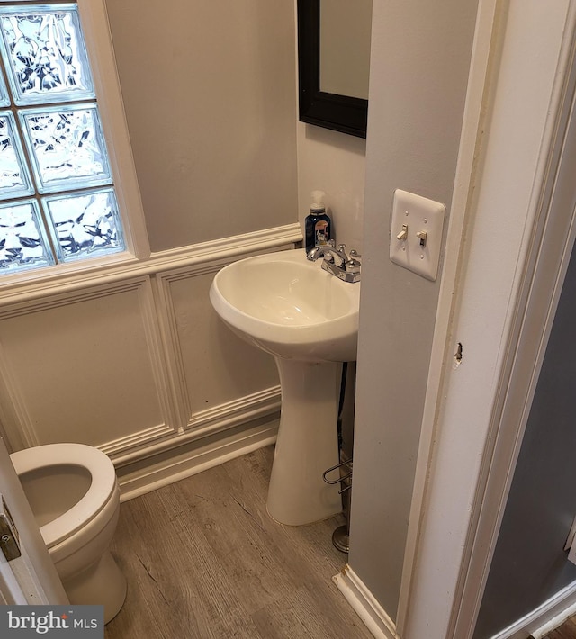 bathroom featuring wood-type flooring and toilet