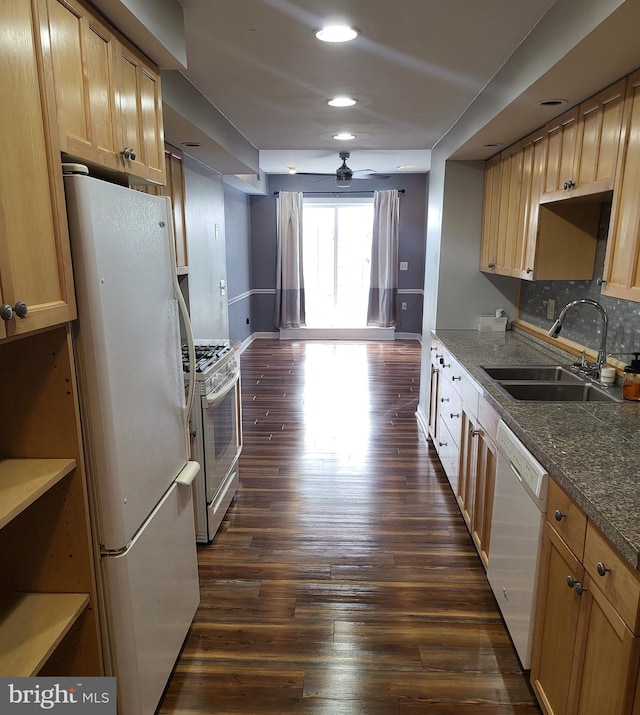 kitchen with decorative backsplash, white appliances, light brown cabinets, dark hardwood / wood-style flooring, and sink