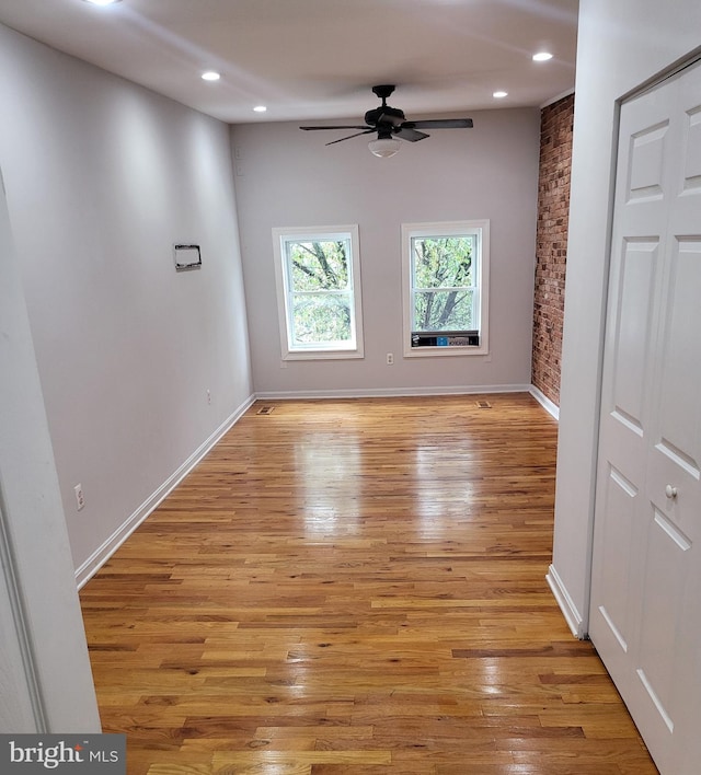 spare room featuring ceiling fan and light hardwood / wood-style floors